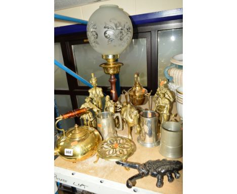 A COLLECTION OF METALWARE, comprising a brass squatt kettle having amber glass handle, a brass kettle with candle under on fr
