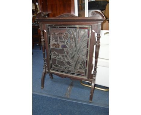 AN EDWARDIAN OAK AND LEAD GLASS FIRE SCREEN with folaite design to the lead work, width 80cm x depth 28cm x height 99cm 