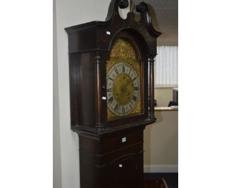 A LATE 19TH/EARLY 20TH CENTURY OAK EIGHT DAY LONGCASE CLOCK, the hood with a swan neck pediment and flanked by cylindrical co