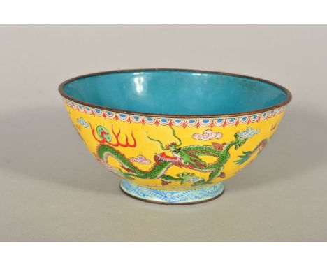A CHINESE ENAMEL FOOTED BOWL, with metal rims, painted with a band of Dragons on a yellow ground, blue factory mark to unders