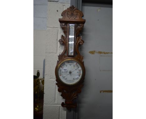 AN EDWARDIAN OAK ANEROID BAROMETER (sd to glass)