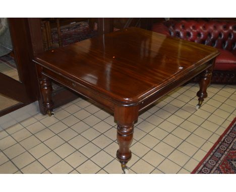 A VICTORIAN WALNUT WIND OUT DINING TABLE, with a Samuel Hawkins winding mechanism, on turned legs and large white ceramic cas