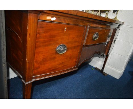 AN EARLY 19TH CENTURY MAHOGANY AND INLAID BOW FRONT SIDEBOARD, fitted with a single drawer above a reeded wavy apron, flanked