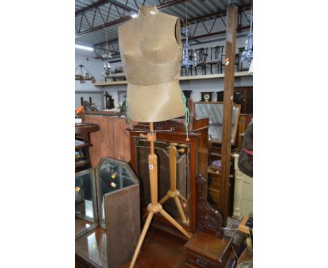 A VINTAGE DRESSMAKERS MANNEQUIN on a teak tripod stand