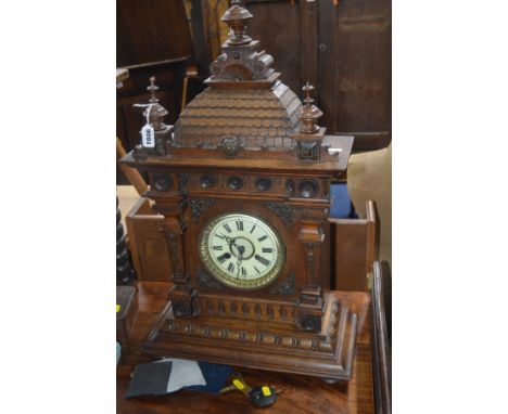 AN EARLY 20TH CENTURY CARVED OAK BRACKET CLOCK, later Smiths movement, the enamel dial with Roman numerals, dial diameter 13c