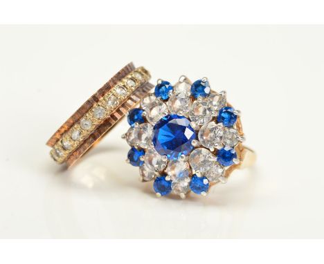 TWO 9CT GOLD RINGS, the first a tiered blue and colourless paste cluster ring, ring size O, the second a band ring set with a