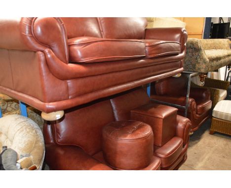 A RED LEATHER THREE PIECE LOUNGE SUITE comprising of a two seater settee and smaller two seater settee together with a simila