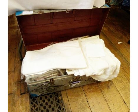 Large quantity of table linen including cloths, mats, napkins, etc., all held within a vintage tin trunk 