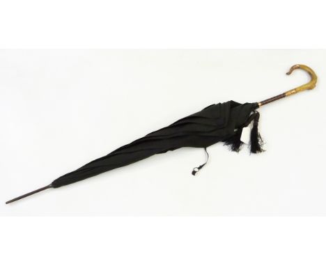 Vintage umbrella with a carved faux horn handle, gold-coloured metal ornate collar and tip with faux-wood 