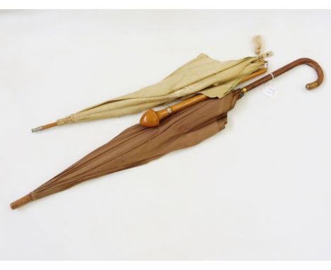 Vintage cotton parasol, embroidered, the handle folding into its original box and a vintage umbrella with leather handle and 