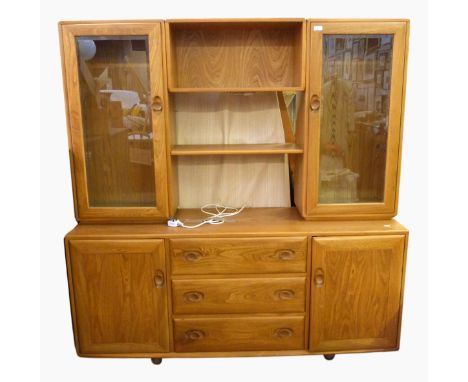 Ercol elm side cabinet, the raised top with pair glazed display cupboards flanking two shelves, the base with three central d