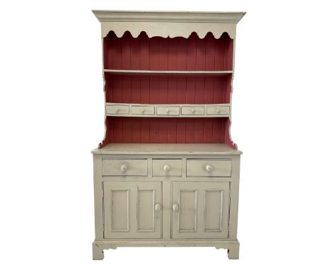 Cream painted dresser, the projecting cornice over two height plate rack with drawers, over three drawers and two cupboard do