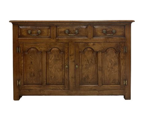 20th century oak sideboard, fitted with three drawers over two cupboard doors, opening to reveal one shelf, raised on stile s