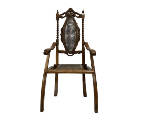 19th century walnut folding campaign chair, the carved cresting rail over bergere back and seat panel, raised on squared supp