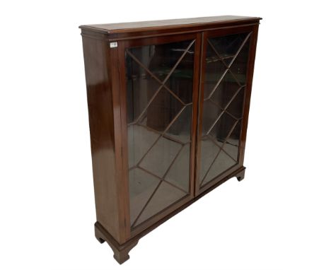 Victorian mahogany gun cabinet, two glazed doors of astragal design opening to reveal fifteen gun stands, raised on bracket s