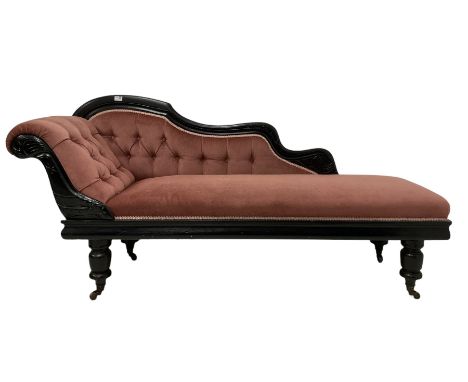 Victorian chaise longue in buttoned upholstery on ebonised frame, raised on turned supports, terminating in ceramic castors 