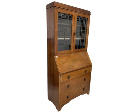 Edwardian walnut bureau bookcase, lead glazed doors over fall front with fitted interior over three drawers, raised on bracke