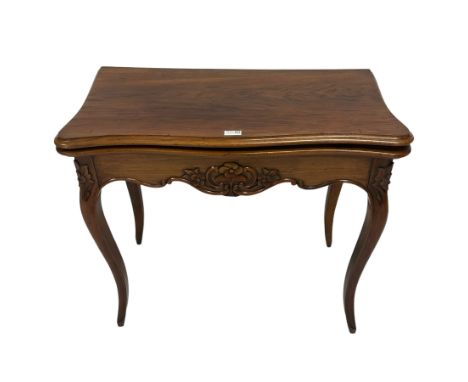 19th century French walnut card table, shaped and moulded fold-over top with inset, shaped frieze and uprights carved with fl