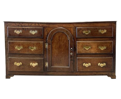 18th century and later oak dresser base, with one central cupboard opening to reveal two fixed shelves, flanked by six gradua
