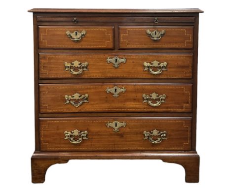George III walnut bachelors chest, the rectangular top with chequered inlay, over dressing slide and two short and three long