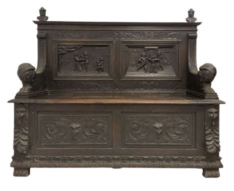 Late 19th century carved oak monks bench, the back panel with carved figures over hinged seat and base with carved masks Dime