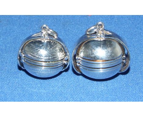 Two silver opening ball lockets
We will post this item worldwide at cost.