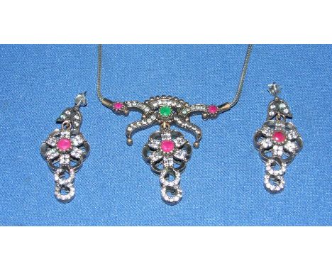 A pair of silver, ruby and emerald earrings, with a matching necklace
We will post this item worldwide at cost.