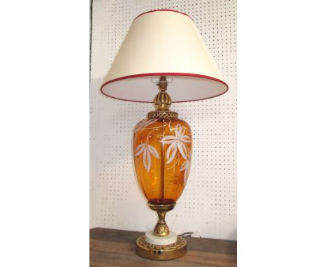 TABLE LAMP, amber glass with gilt detail and a cream shade having a red trim, 83cm H overall. 
