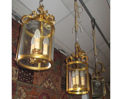 HALL LANTERNS, a pair, originally purchased from Christopher Wray, cylindrical gilt metal with curved glass, 43cm H x 23cm W,