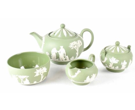 A Wedgwood sage green four-piece tea set to include teapot, lidded sucrier, milk jug and slop bowl, all decorated with white 