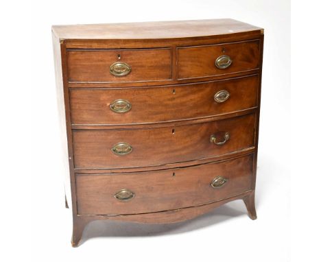 A Regency cross-banded mahogany bow-fronted chest of drawers, two short and three long drawers with brass drop handles, on ou