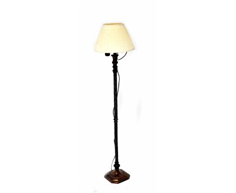 A modern metal standard lamp with reeded wrythen column on an octagonal stepped base with cream shade, height 132cm.