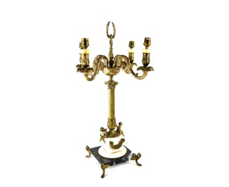 A table lamp in the form of an Empire-style gilt metal four-branch candelabrum, with Corinthian column, on a square marble ba