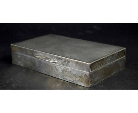 A George VI hallmarked silver engine turned cigarette box with interior wood lining, length 15cm, Birmingham 1941-42, maker's