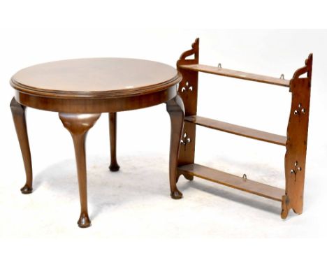 A mid-20th century walnut circular top occasional table on cabriole legs, height 46cm, diameter 60.5cm and an oak wall shelf 