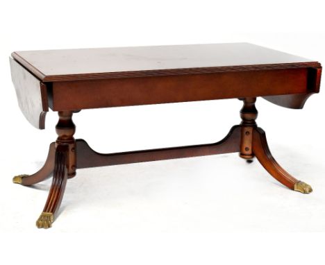 A Regency-style mahogany sofa table on twin pedestal base united by stretchers, with outswept reeded legs, 50 x 102 x 53cm.