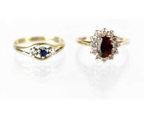 Two hallmarked 9ct gold rings, one with ruby cluster with twelve small diamonds, size L, the other sapphire flanked by two sm