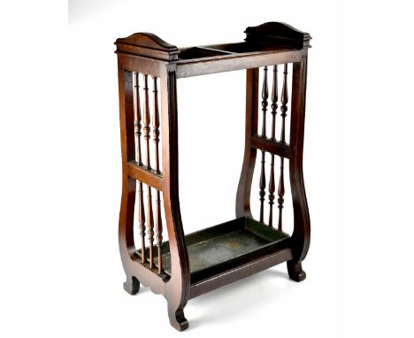 A 19th century mahogany stick stand with double single division, lyre sides with bobbin turned spindles and tin drip tray, he