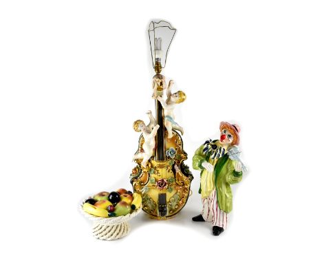 A Continental porcelain lamp base in the form of a violin with putti and encrusted with roses, height 66cm, a modern pottery 