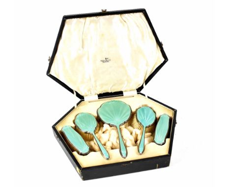 A George V five-piece hallmarked silver and turquoise engine turned enamel dressing table set comprising hand mirror, two han