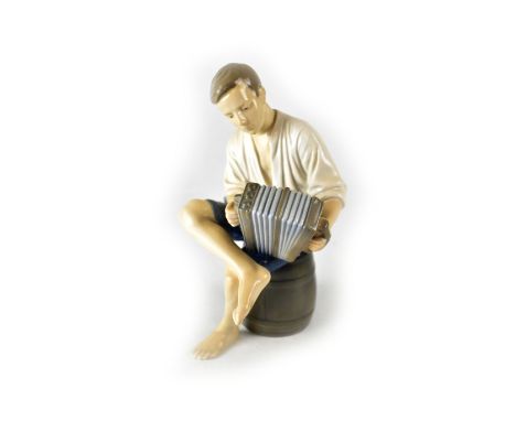 A Bing &amp; Grondahl porcelain model of a seated accordion player, marks to base, numbered '1661 VI', height 22cm.
