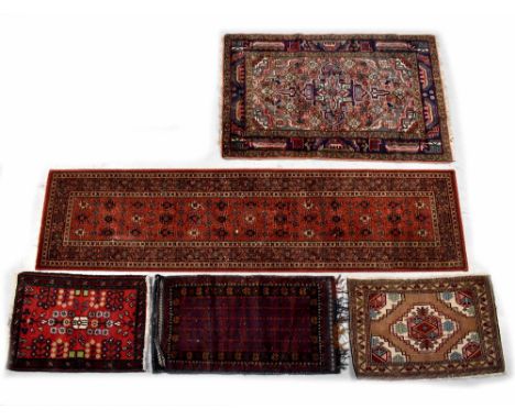A Keshan wool hall runner, red ground with multi-medallions, 273 x 69cm, three various wool prayer rugs, one other wool rug w