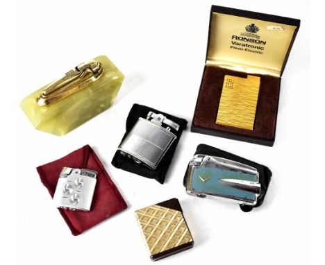 Five Ronson lighters to include an onyx table lighter, a blue painted chevron motif lighter in leather case, two textured lig