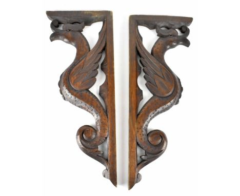 A pair of c1920s carved oak railway luggage brackets, each right-angled bracket carved with a Liver Bird support, height 53cm