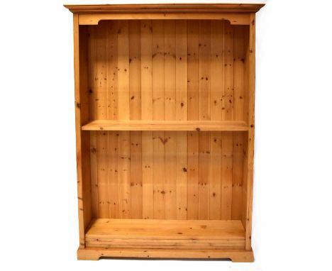 A pine floorstanding bookcase with a moulded top and five shelves, on bracket feet, 185 x 132 x 35cm.