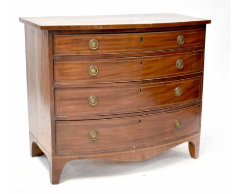 An early 19th century mahogany bow-fronted chest of four long graduating drawers, each with cross-banded inlay and with press