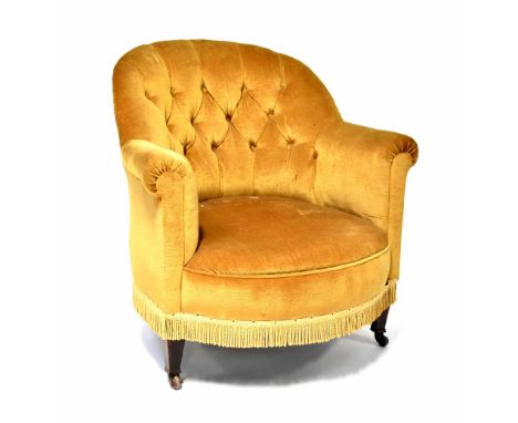 A 1930s mahogany-framed button-back tub armchair upholstered in mustard velour. CONDITION REPORT Scuffs and nibbles to legs, 
