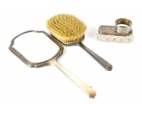 A hallmarked silver engine turned hand mirror and brush, a cut glass rectangular trinket pot with hallmarked silver top and a