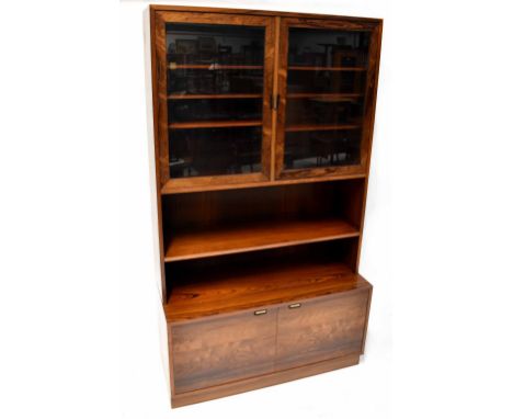 A Danish mid-20th century rosewood display cabinet with glazed top over open shelves, the base with pair of cupboard doors, o