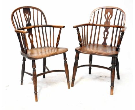 A 19th century elm seated Windsor stick-back armchair with pierced splat, on turned legs united by crinoline stretcher and an